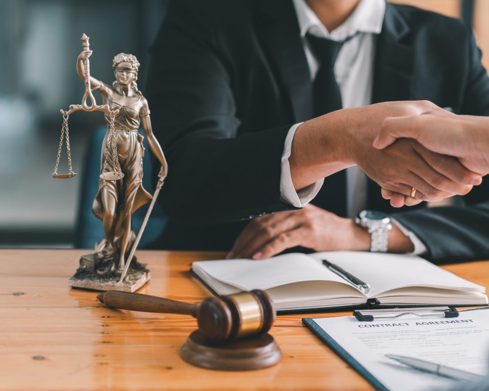 Handshake after good cooperation, Consultation between a male lawyer and businessman customer, tax and the company of real estate concept.