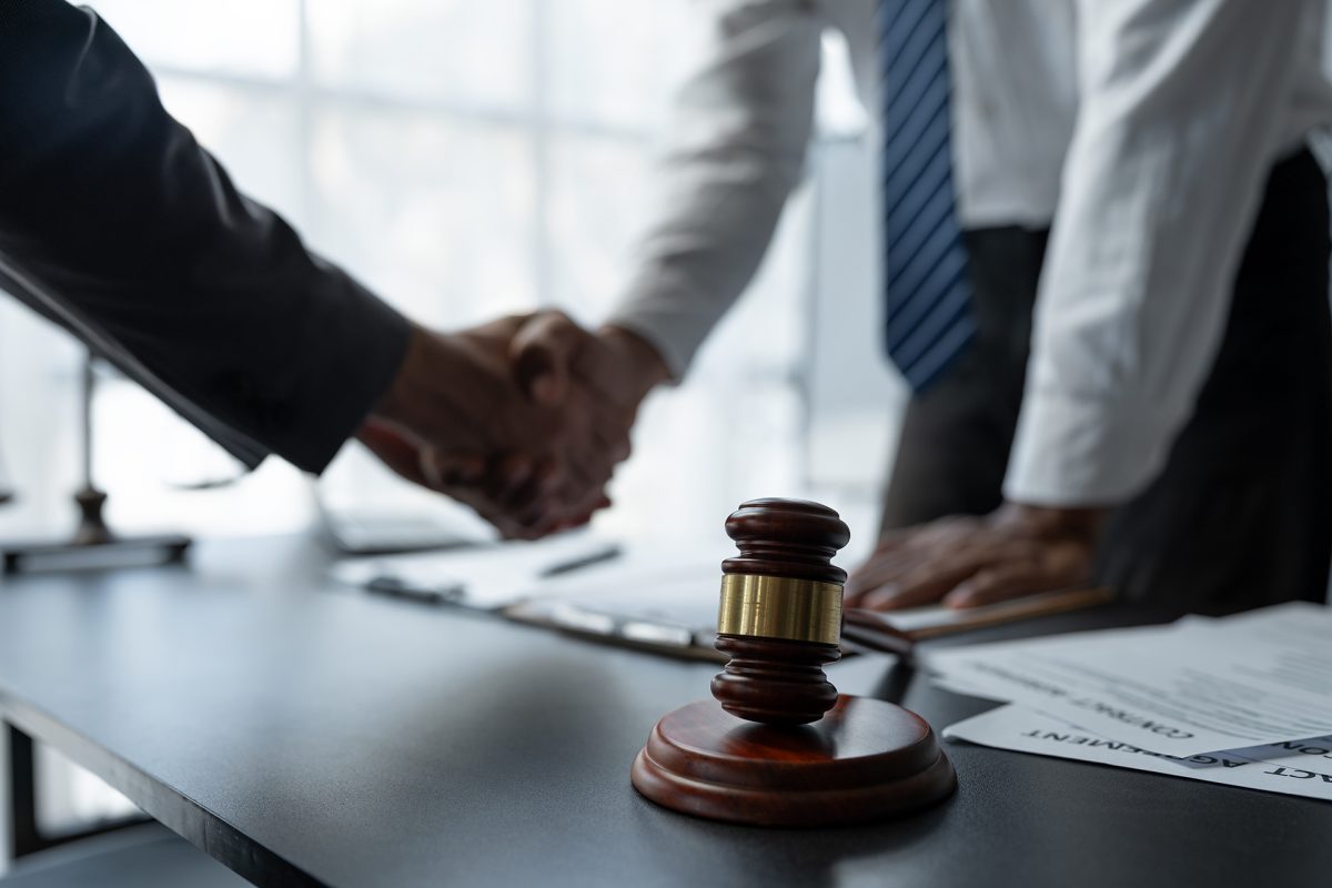 The handshake after a good cooperation, consulting between attorney and client, businessman, tax and real estate project company. Law and justice concept